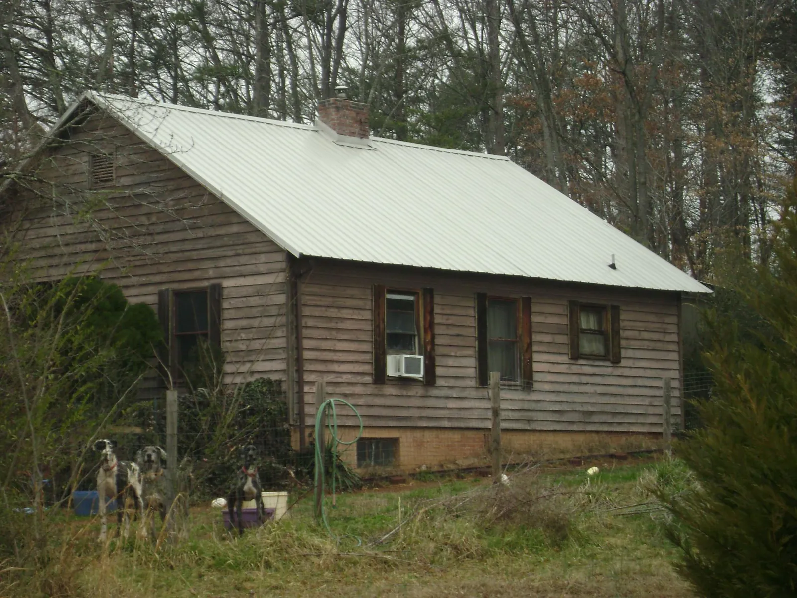White metal roof on an old wood sided farmhouse, from a Metal Roof Installation job in Paxton